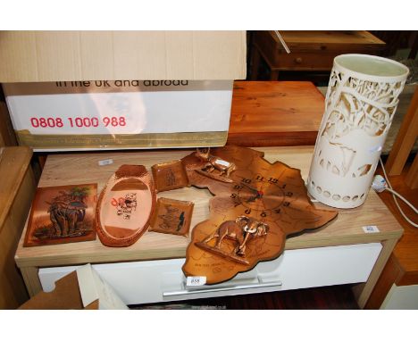 Copper African dishes, clock and a silhouette lamp.