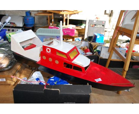 A wooden model boat with small electric driven motor, (No remote).