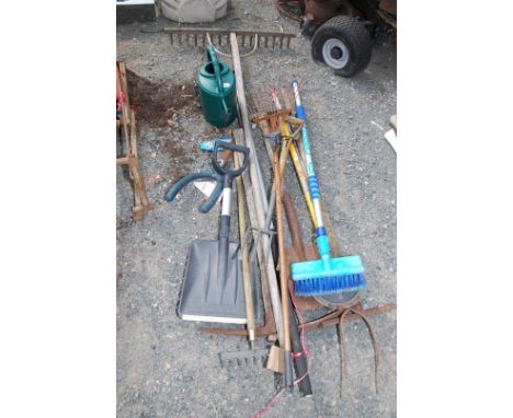 A quantity of garden tools; pike, spade, rakes, watering can, etc.