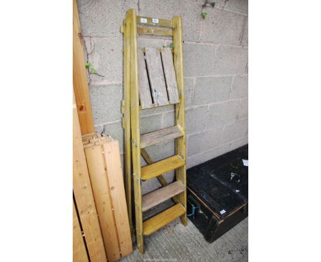 A five rung wooden step ladder.