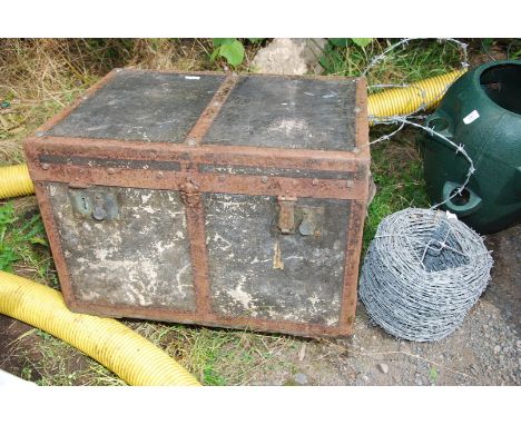 A roll of barbed wire and an old trunk.