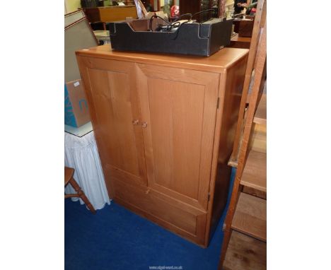 A light oak Music centre Cupboard, made by Grahame Amey, Crickhowell with tiered shallow shelves and drawer with compartments