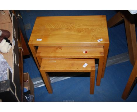 A nest of three light Oak Tables, stamped "Abel".
