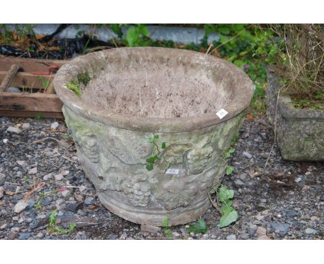 A round large planter with grapevine and butterfly decoration. (241/2" diameter x 18" deep).