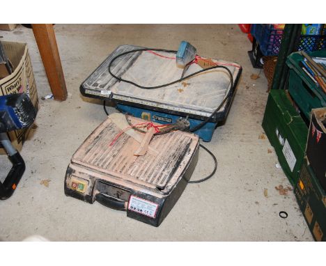 Two electric tile cutters.