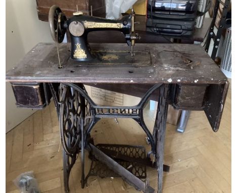 Singer Sewing Machine on cast iron treadle operated table.Some damage to woodwork. THIS ITEM IS OFF SITE AND SHOULD BE COLLEC