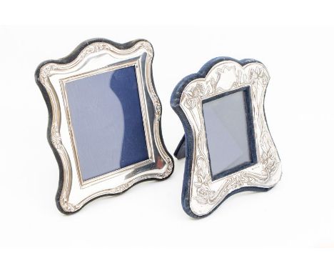 Two silver photo frames to include; A stylised floral Art Nouveau style silver easel form frame with fabric back, hallmarked 