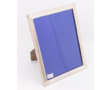 A large silver photo frame, with plain and ribbed design, hallmarked London, 1985, maker AB, approx. 27.5cm high x 21.5cm wid