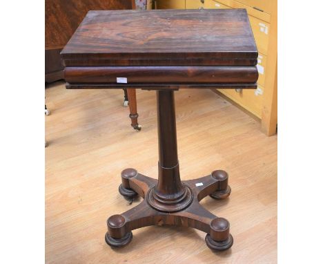 A small rose mahogany games table on four padded feet with castors, the lift-up lid reveals chequerboard and velvet card-play