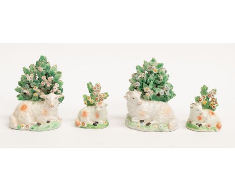 Two pairs of early Derby factory porcelain figures of sheep lying down surrounded by foliage. There are patch marks on the ba