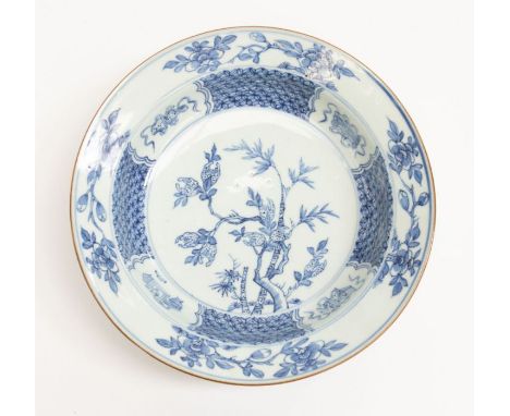 A Chinese export blue and white bowl, decorated with magnolia tree to centre within geometric vignettes, scroll and book moti