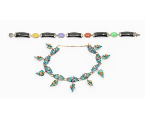 A coloured jade and silver set bracelet, comprising black black panels with various coloured oval cabochon jade, Chinese scri