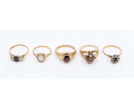 A collection of 9ct gold stone set rings to include a opal, size P, smoky quartz, size N,  a garnet ring, sizes S, stone abra