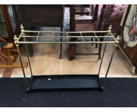 A brass and steel stick stand.With 12 divisions, turned brass baluster finials and a painted steel trough fitted to the base 