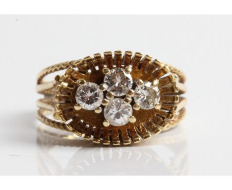 A diamond cluster ring, set with four round brilliant cut diamonds, each 0.15ct, in a raised gallery with rope twist design t