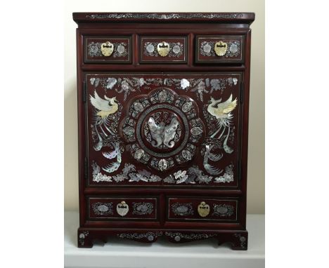 A Chinese lacquerware style jewellery box chest fitted to front with five drawers and two doors, two long and two short drawe