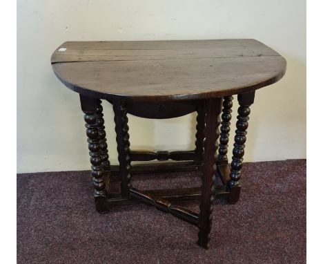 An 18th century oak small gate leg table on turned bobbin supports, height 64cm. IMPORTANT: Online viewing and bidding only. 