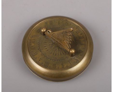 A reproduction brass sundial compass. Signed Gilbert.  