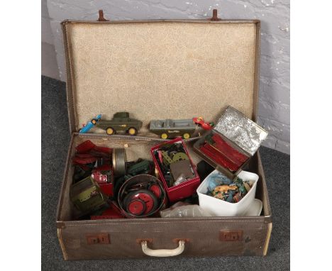 A vintage suitcase with a quantity of green and red meccano pieces &amp; automobile accessories.  