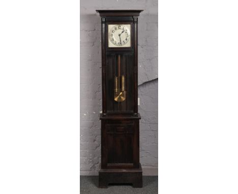 A George V oak cased 8 day longcase clock. With silvered square dial having Arabic numeral markers, astragal glazed trunk and