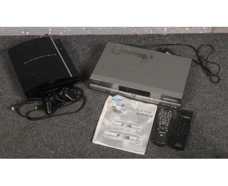 A playstation 3 console with controller along with a DVD player.  