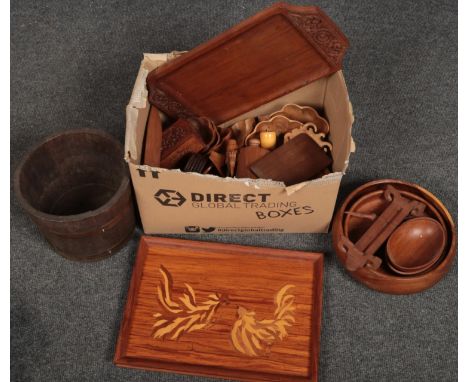 A box of wooden wares including a marquetry tray depicting fighting cockerels, a coopered planter and a quantity of carved bo