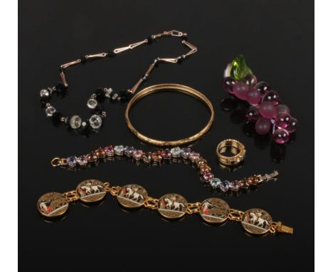 A yellow metal bangle, two bracelets one set with coloured heart shaped stones, a jet and crystal necklet and a garnet, jade 
