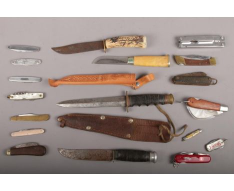 A box of assorted knives including a Swiss army multi tool knife, Taylor of Sheffield hunting knife, assorted pocket knives a
