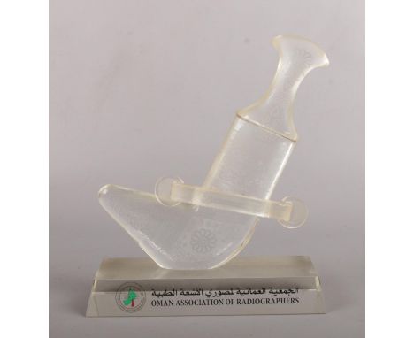 Oman association of radiographers, four cased glass trophies, one in the form of a Khanjar dagger.  