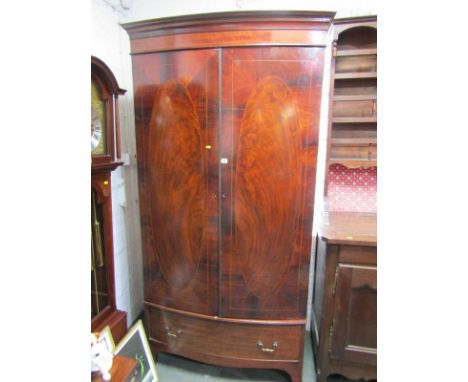 HEPPLEWHITE DESIGN BOWFRONTED TWIN DOOR WARDROBE, oval inlaid flambe mahogany doors with single drawer base and splayed brack