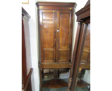 PROVINCIAL GEORGIAN MAHOGANY CORNER CUPBOARD, twin panelled doors, fitted interior and later shelf based stand, 81" height 31