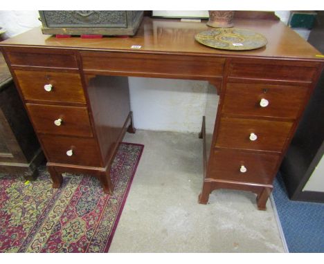 ART DECO MAHOGANY KNEEHOLE DESK, turned ivory knop handles with drop front central frieze drawer and splayed bracket feet, 43