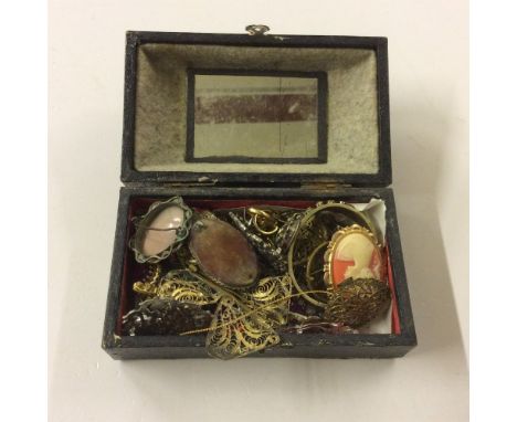 A leather box of various costume brooches and a bangle etc. 