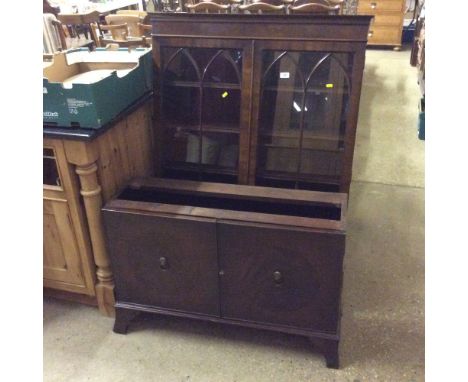 A mahogany and glazed cabinet raised on cupboard base AF