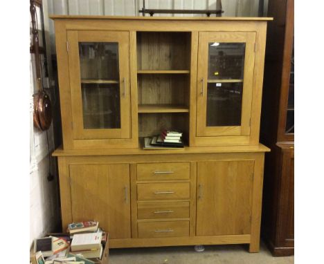 A modern light oak and glazed dresser 
