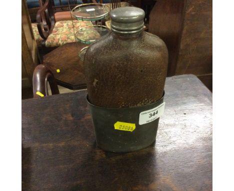 A pewter and leather mounted hip flask 