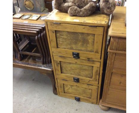 A stripped pine three door cabinet 