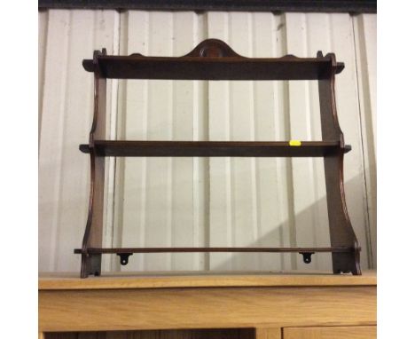 An oak three tier wall shelf 