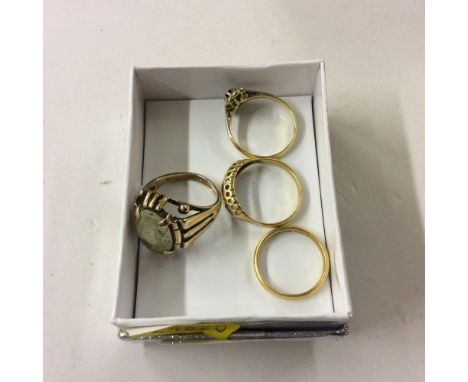 A 22ct gold wedding band; a 14ct gold ring; and two 18ct gold rings 