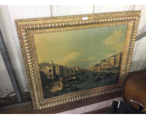 A large gilt framed print of a Venetian canal scene 