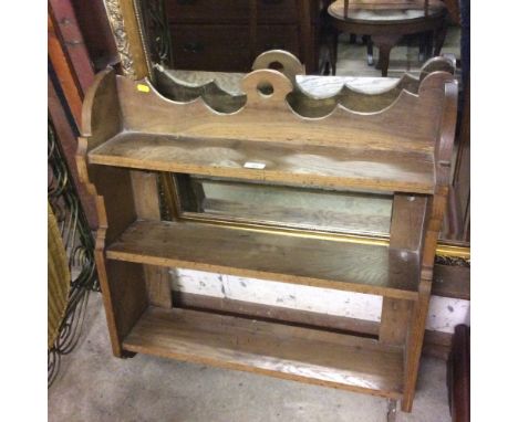 An oak three tier wall shelf 