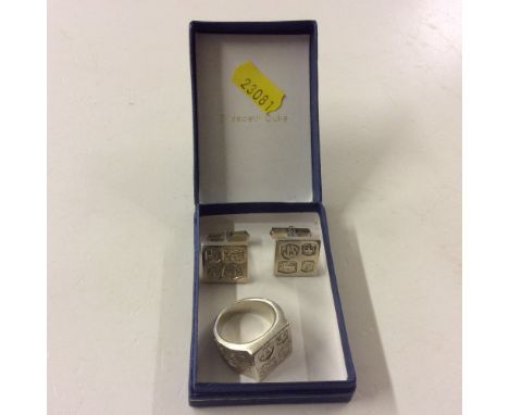 A gent's modern silver ring; together with a pair of matching cuff-links 