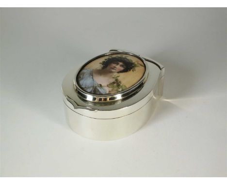 A Goldsmiths &amp; Silversmiths Co Ltd silver trinket box with enamelled and hand painted oval plaque, London 1911, the plain