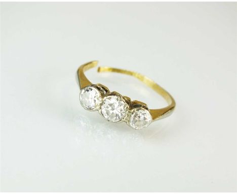 A graduated three stone diamond ring, the brilliant cut diamonds collet and claw set in white metal to yellow metal shank, st