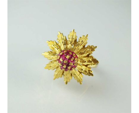 A ruby floral cluster ring, designed as a raised cluster of faceted rubies claw set to tapering textured petals, the yellow m