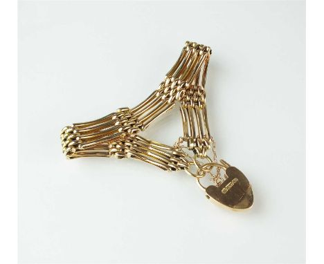 A yellow metal four bar gate link bracelet, the heart shaped padlock clasp stamped '9ct', with attached safety chain, weight 