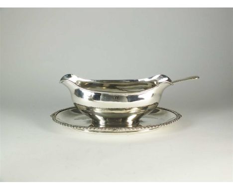 An Egyptian silver sauce boat on stand, the oval boat mounted to stand with gadrooned rim, together with a matching silver sa