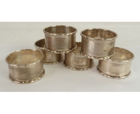 SET of 6 SILVER CIRCULAR NAPKIN RINGS, engine turned and with raised borders, Birmingham, 1972, 3 x 18 oz