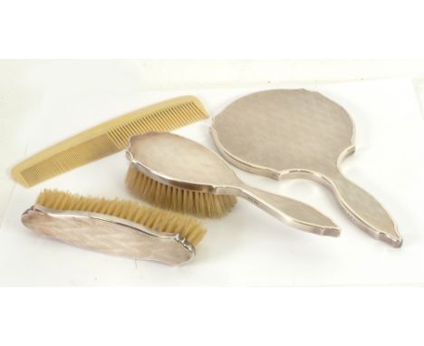 GEORGE V CASED THREE PIECE ENGINE TURNED SILVER DRESSING TABLE HAND MIRROR AND BRUSH SET, London 1935 and a  COMB 