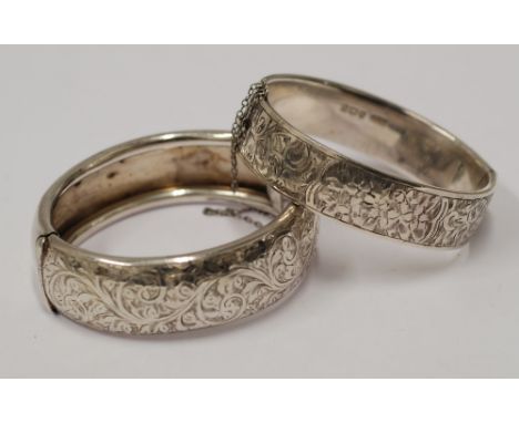 SILVER BROAD HINGE OPENING BANGLE, with foliate scroll engraved top, Chester hallmark 1945 and  ANOTHER SIMILAR BUT SMALLER S